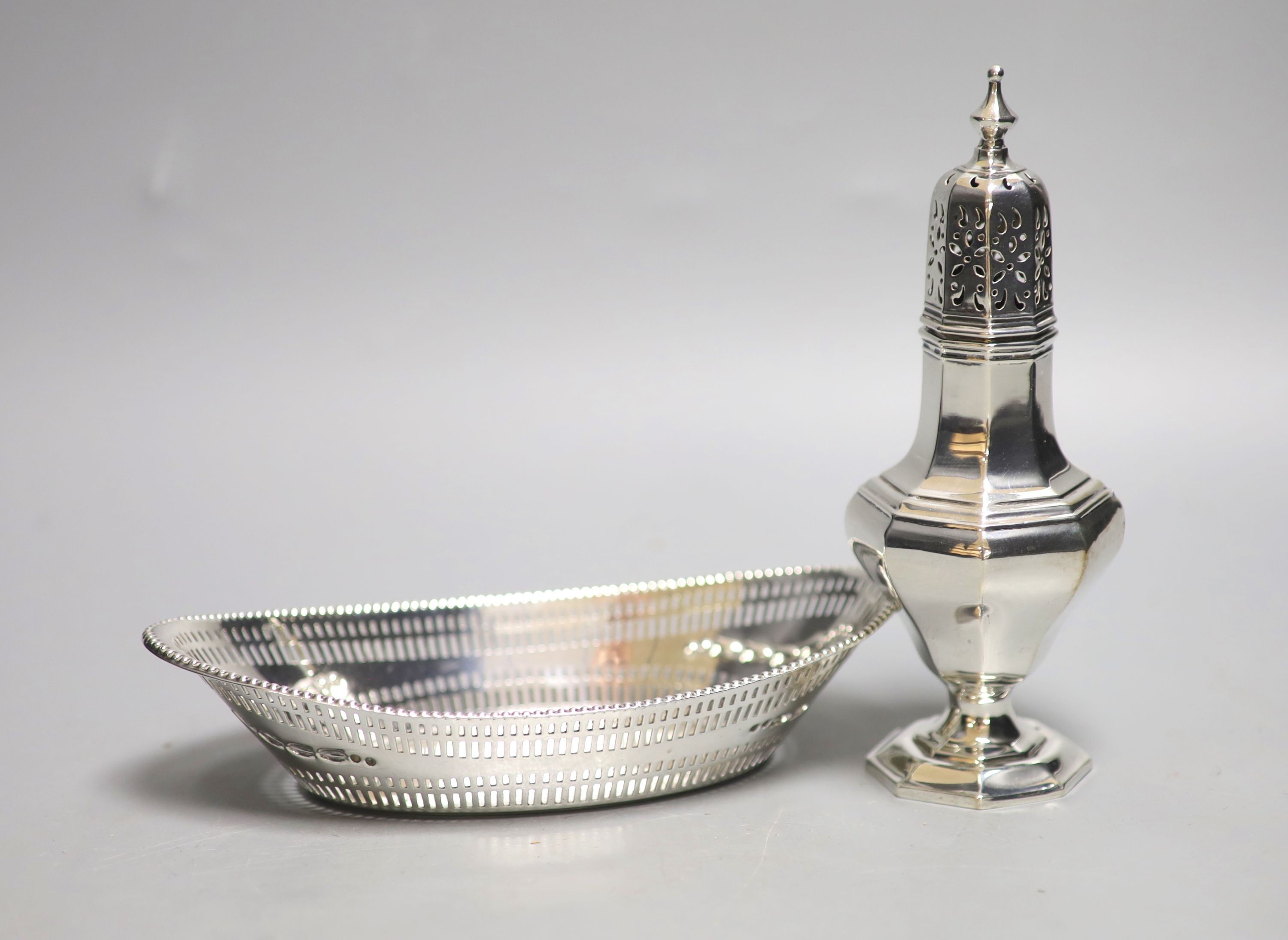 A late Victorian pierced silver oval dish, Sheffield, 1896, 18.7cm and a later silver sugar caster, 6.5oz.